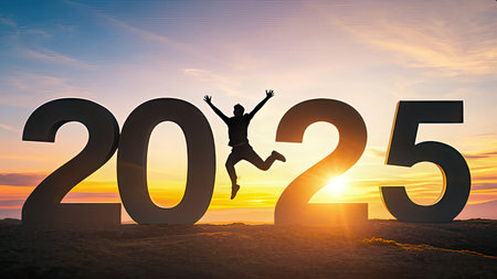 Silhouette of happy young man jumping over new year 2015 backgroundの素材