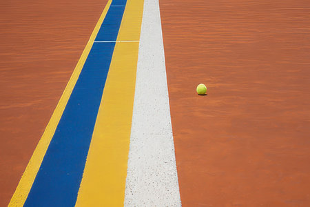 Tennis court with white line and ball on it. Close up.の素材