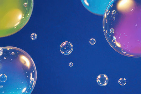 colorful soap bubbles on a blue background. macro shot of soap bubblesの素材
