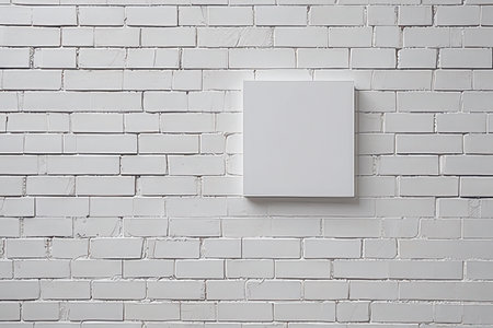 blank photo frame hanging on a white brick wall with copyspaceの素材