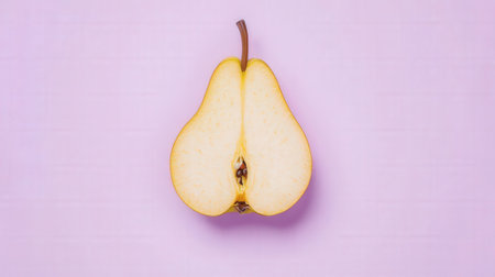 Half of a ripe pear on a pink background. Top view.の素材