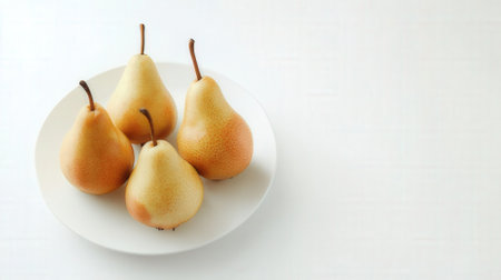 Ripe pears on a white plate on a white background.の素材