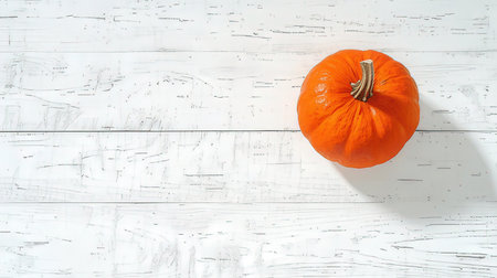 Pumpkin on white wooden background. Top view with copy spaceの素材