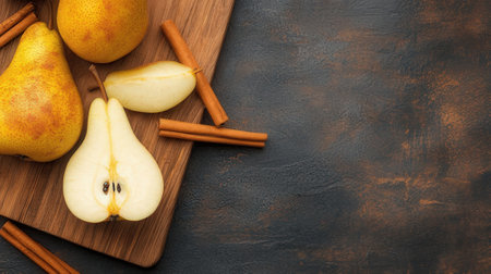Ripe pears and cinnamon sticks on wooden cutting board. Top view with copy spaceの素材