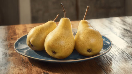 Ripe yellow pears on a blue plate on a wooden tableの素材