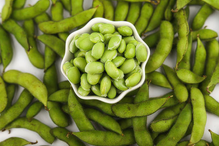 Green soybeans in white bowl isolated on white background, top viewの素材