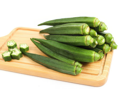 Fresh okra on wooden board isolated on white background, clipping pathの素材