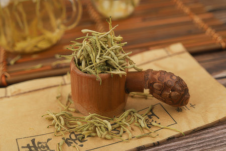 Chinese herbal tea in a wooden cup and teapot on the tableの素材