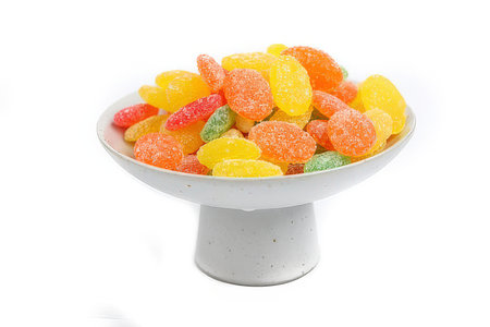 colorful jelly candies in a bowl isolated on white background.の素材