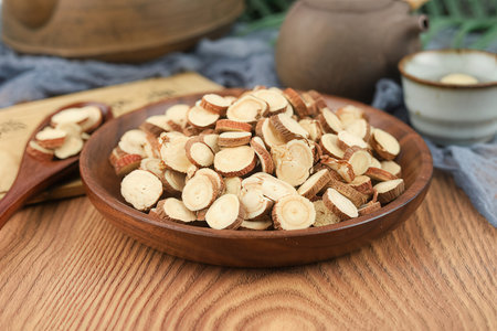 Slices of dried apricots in a bowl on a wooden tableの素材