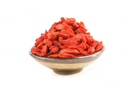 Dried goji berries in bowl isolated on white background. Superfoodの素材
