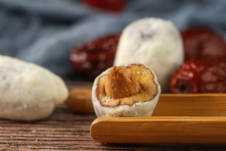 Traditional oriental sweets with dates and raisins on wooden backgroundの素材