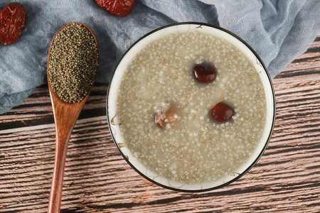 Oatmeal porridge with raisins and chia seeds on wooden backgroundの素材