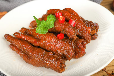 Fried meat with red pepper on a white plate, close upの素材