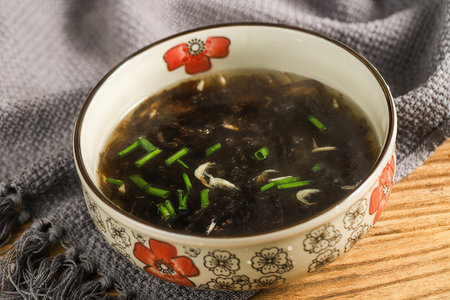 Miso soup in a bowl on a wooden table, close upの素材