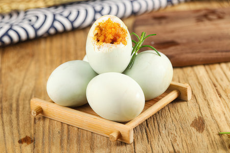 Boiled eggs with egg yolk on wooden background. Closeupの素材