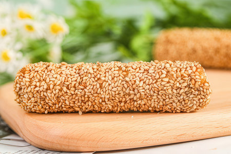 Sesame snack on a wooden board, selective focus.の素材