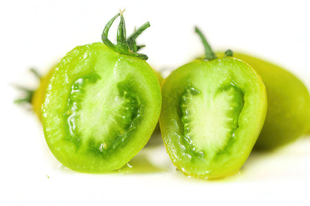 Green tomatoes on a white background. Close-up, macro.の素材