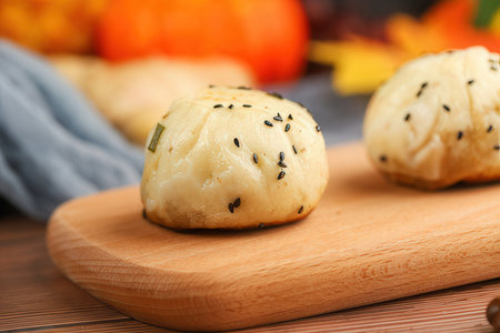 Delicious buns with sesame seeds on wooden board, closeupの素材