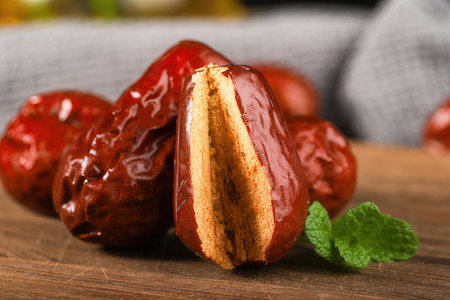 Tasty dates on wooden table, closeup. Dried fruitsの素材