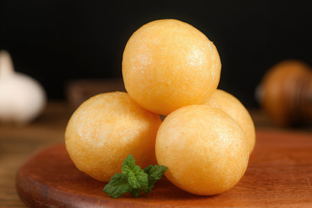 Cantaloupe melons on a wooden board and black backgroundの素材