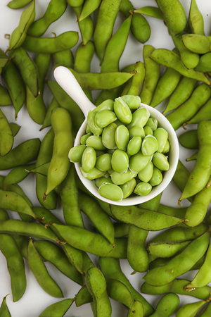 Green soybeans in a bowl on a white background, top viewの素材