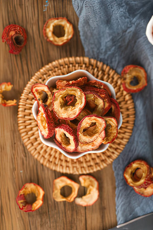 Dried strawberries in a bowl on a wooden background. Selective focus.の素材