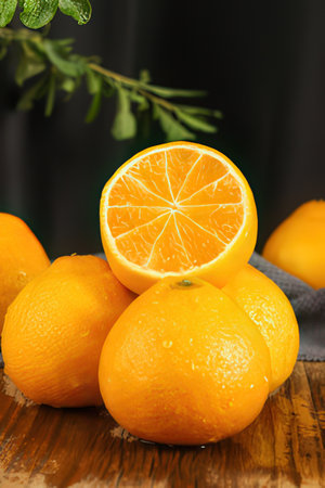 Fresh oranges with water drops on wooden table. Shallow dof.の素材