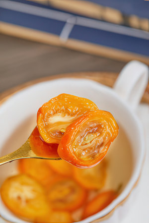 Dried tomatoes on a spoon in a white cup, close upの素材