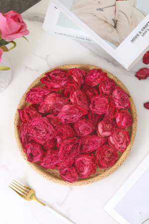 Wicker basket with red roses on a marble table, top viewの素材