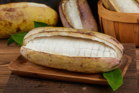 Cocoa pod on a wooden background. Cocoa beans.の素材