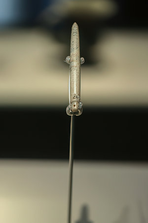 Close-up of an old metal pendulum in a museum.の素材