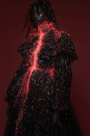 fashionable african american woman in black dress with sparkles