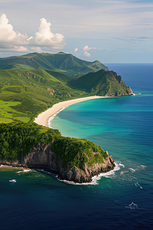 Aerial view of a beautiful sandy beach with turquoise water and green hills in the backgroundの素材