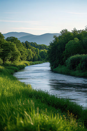 Beautiful summer landscape with river and mountains in the background. Shallow depth of field.の素材