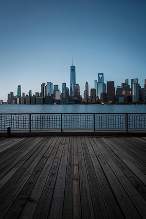 Skyline at dusk with wooden deck and skyscrapers in the backgroundの素材
