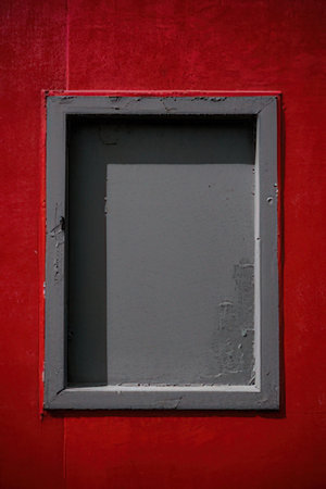 Red wall with a window in the shape of a square. Backgroundの素材