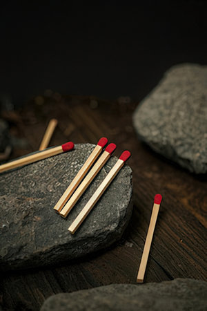 Matches on a wooden background. Dark tone. Selective focus.の素材