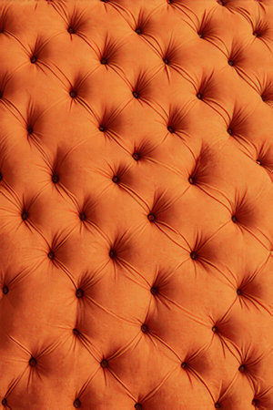 Close up detail of orange leather texture background. Furniture upholstery pattern.の素材