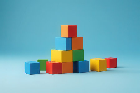 Pyramid of colorful toy blocks on blue background. 3d renderの素材