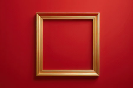 Golden picture frame on red wall. Mockup for your design.の素材