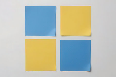 yellow and blue sticky notes on a white background with space for textの素材