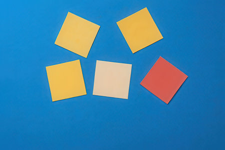 Colorful post it notes on a blue background. Copy space.の素材