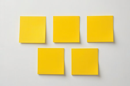 Yellow sticky notes on a white background. Mockup for design.の素材