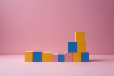 Colorful toy blocks on pink background. Minimalism concept.