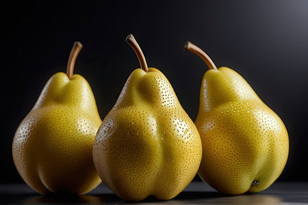 Three ripe yellow pears on a black background, close-upの写真素材