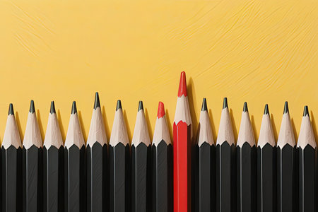 Black and red pencils on yellow background with copy space, top viewの写真素材