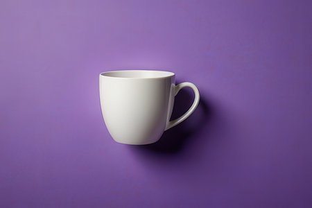 White coffee cup on violet background. Minimal style. Top view.の写真素材