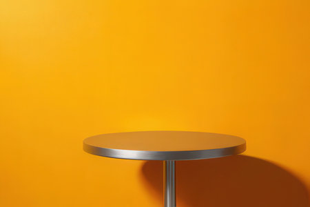Empty round table on orange background. Mockup for design. 3D renderingの写真素材