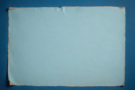 old paper on blue background with space for your text or image.の写真素材